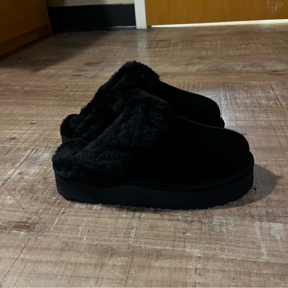 UGG women’s black disquette sheep skin platform slippers